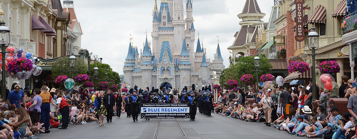 The Franklin Community Blue Regiment Marching Band performing in the Festival of Fantasy Parade at Walt Disney World.