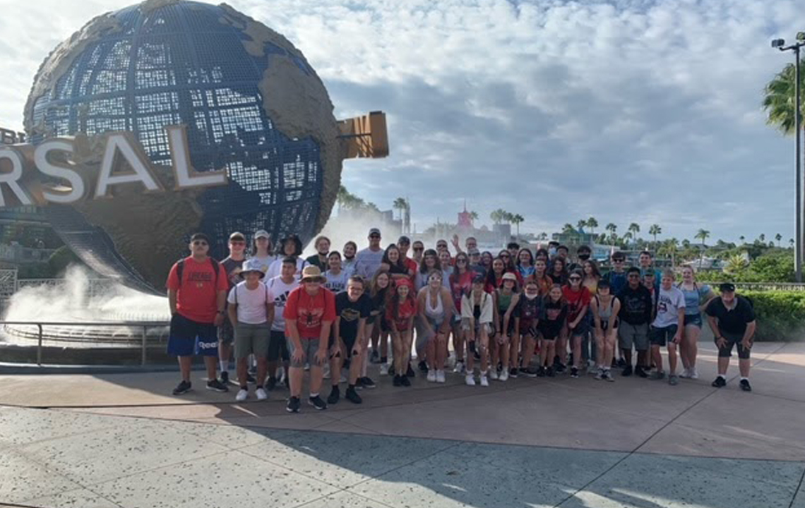 Group members pose by the Universal Studios Globe. A popular meeting place and photo opportunity, almost all groups stop for a group photo.