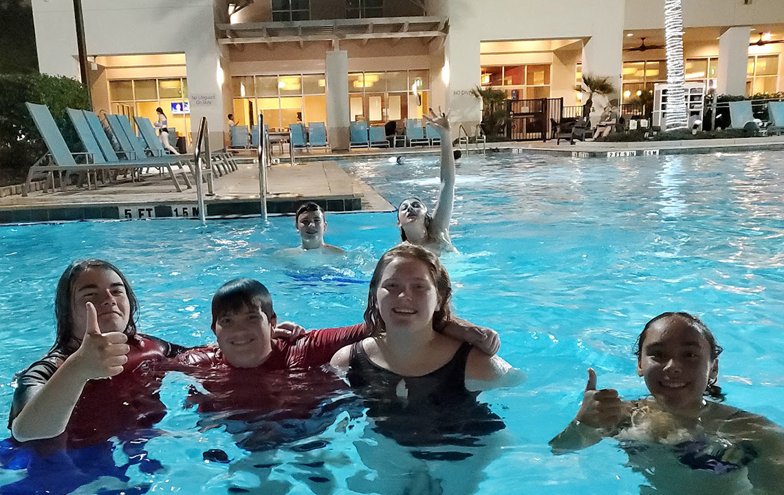 After a long day in the parks, the band enjoys the hotel pool. Warmer weather made it perfect for swimming into the evening hours.