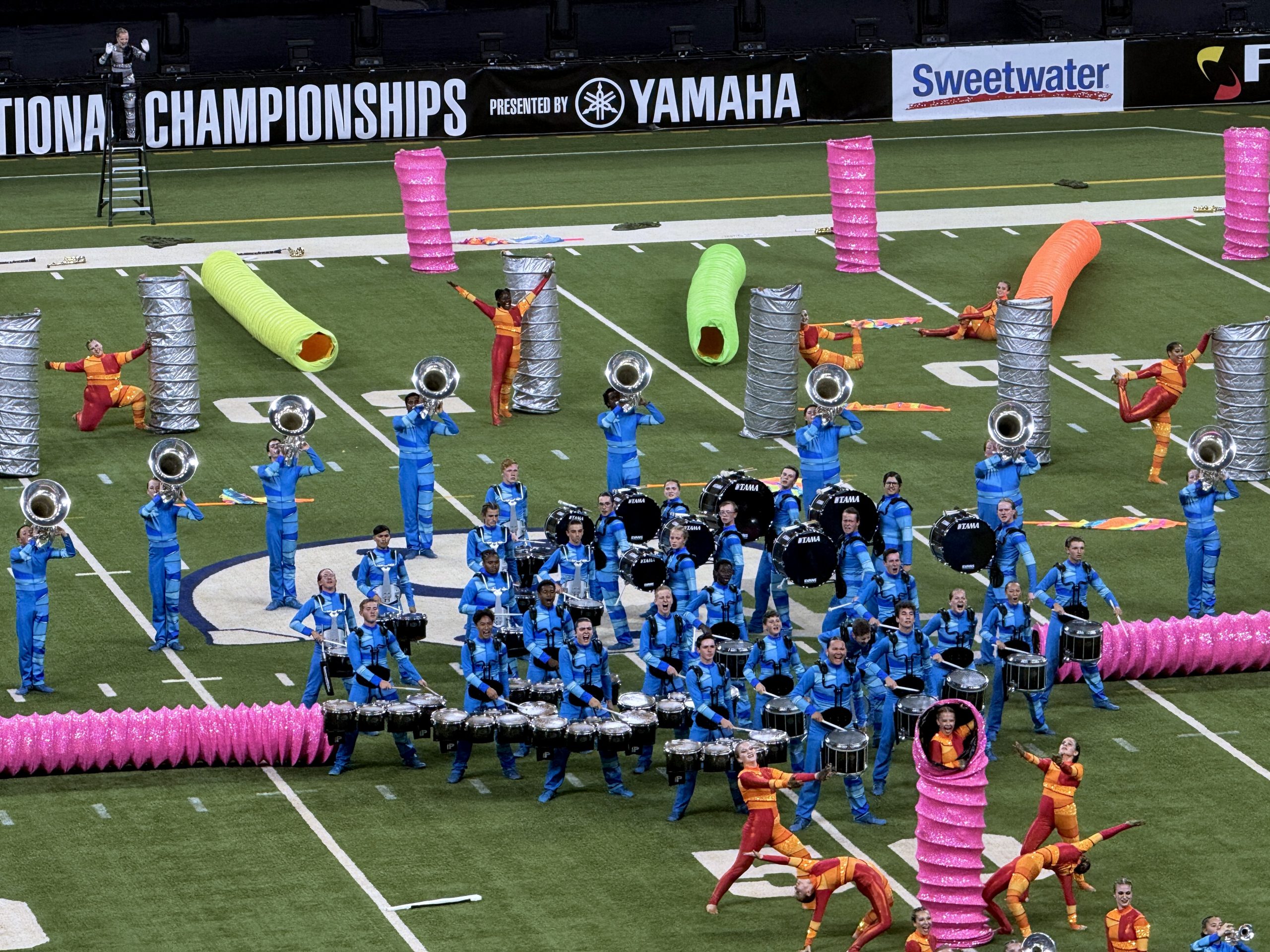 Avon HS band and colorguard students performing on the field at Lucas Oil Stadium