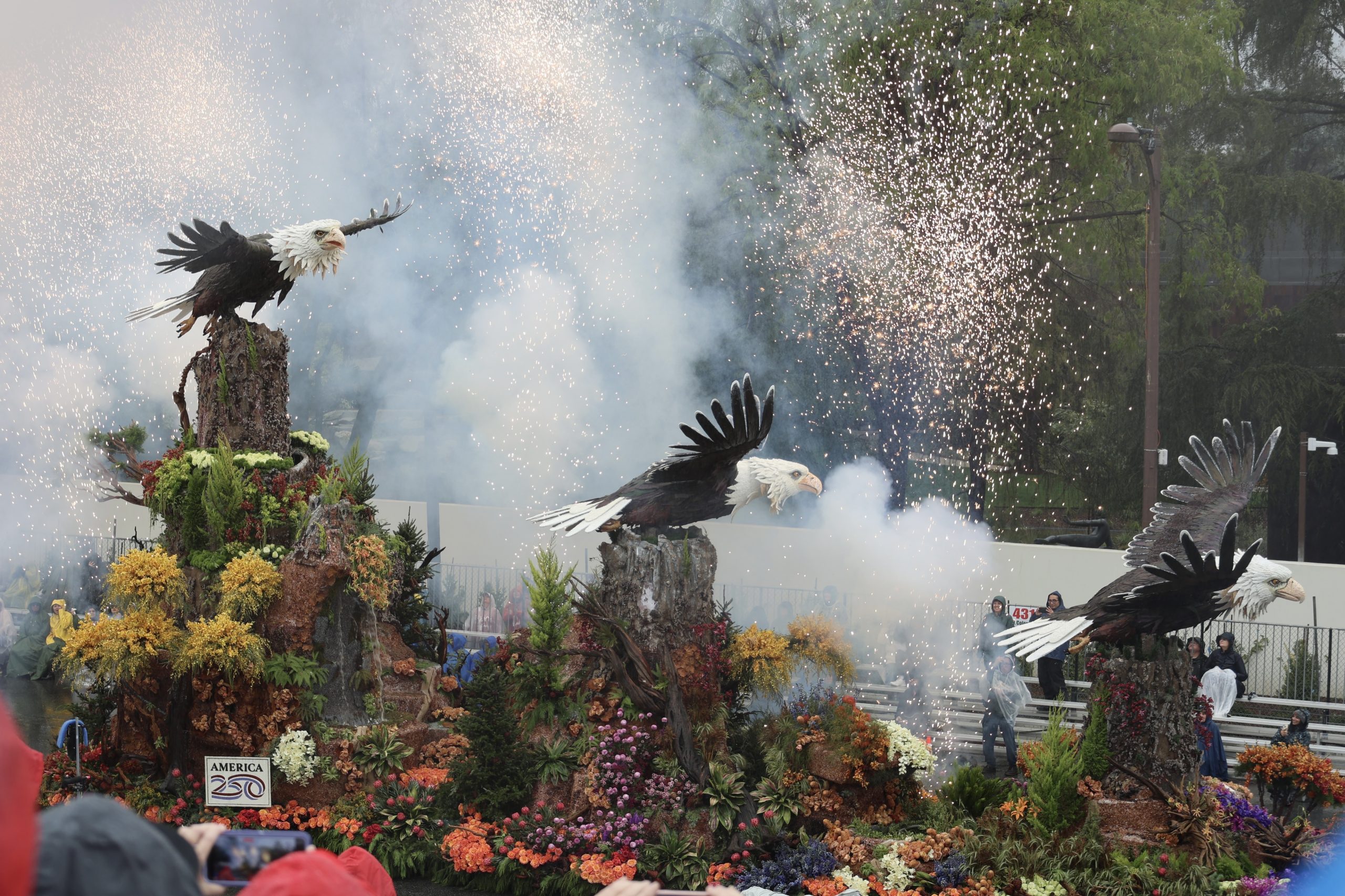 Rose Parade float decorated with three flying eagle figures