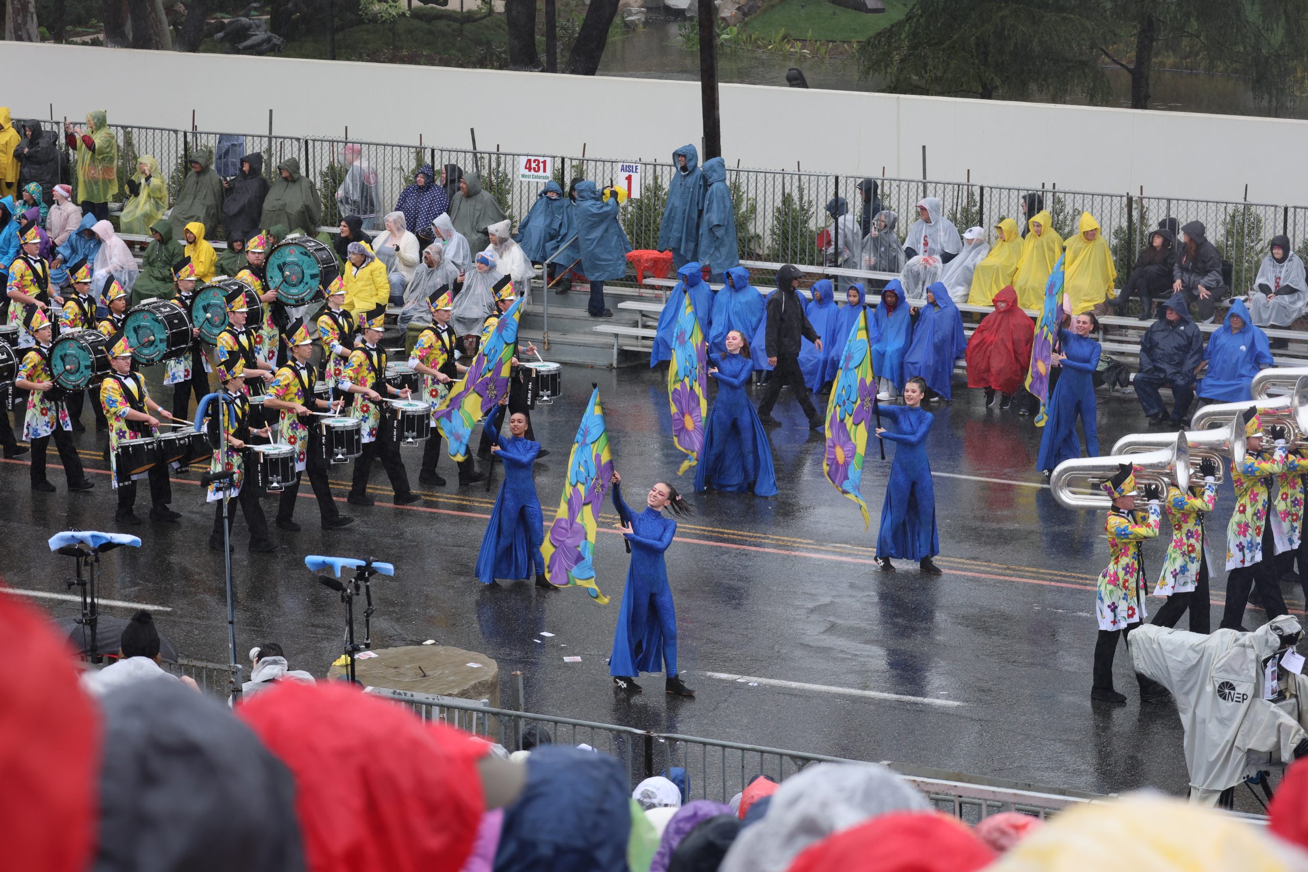 Colorguard and band marching the Rose Parade