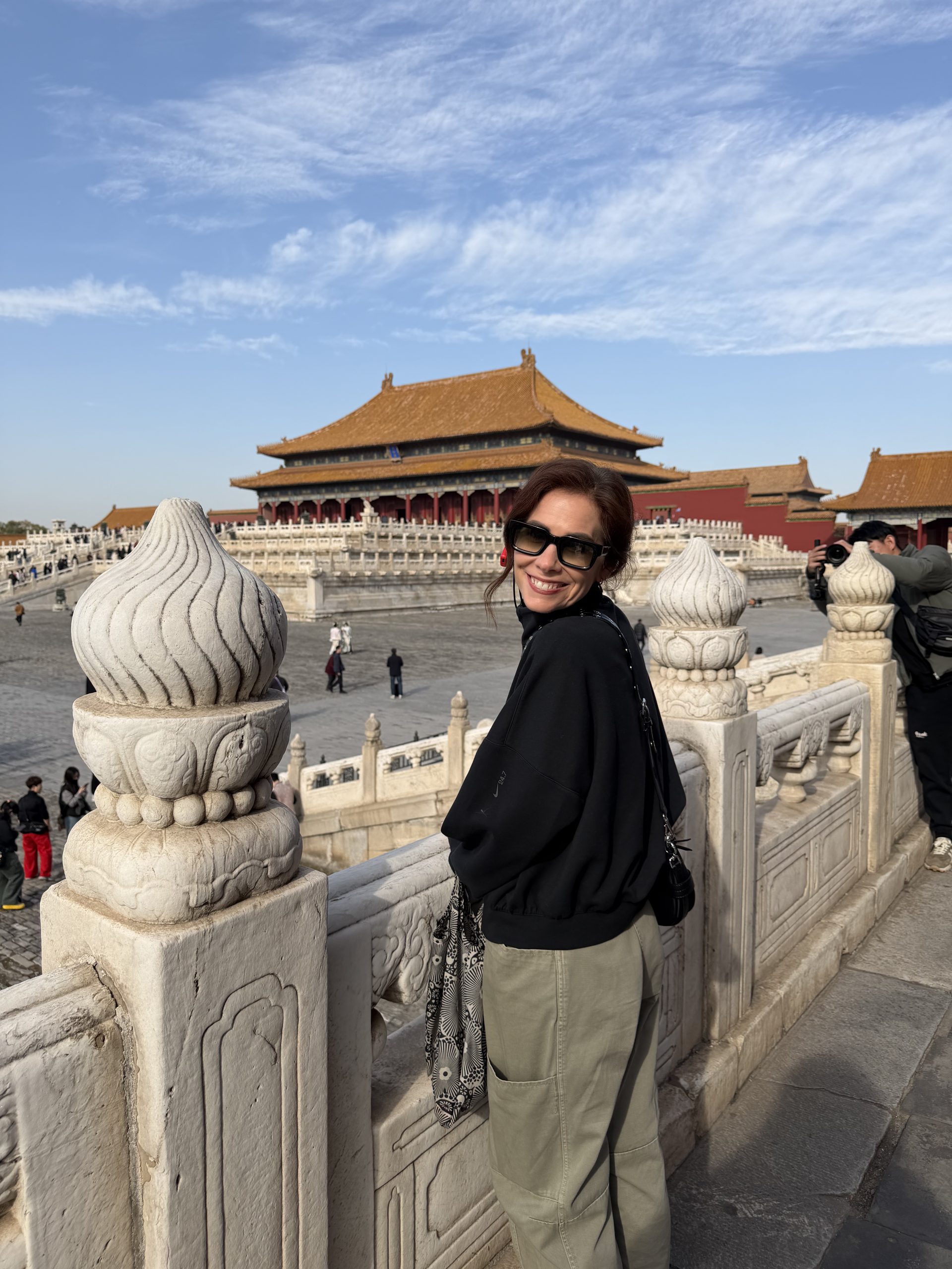 Mary Godley stands in front of a landmark in China