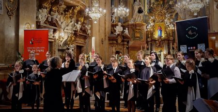 choir students singing with an ornate background