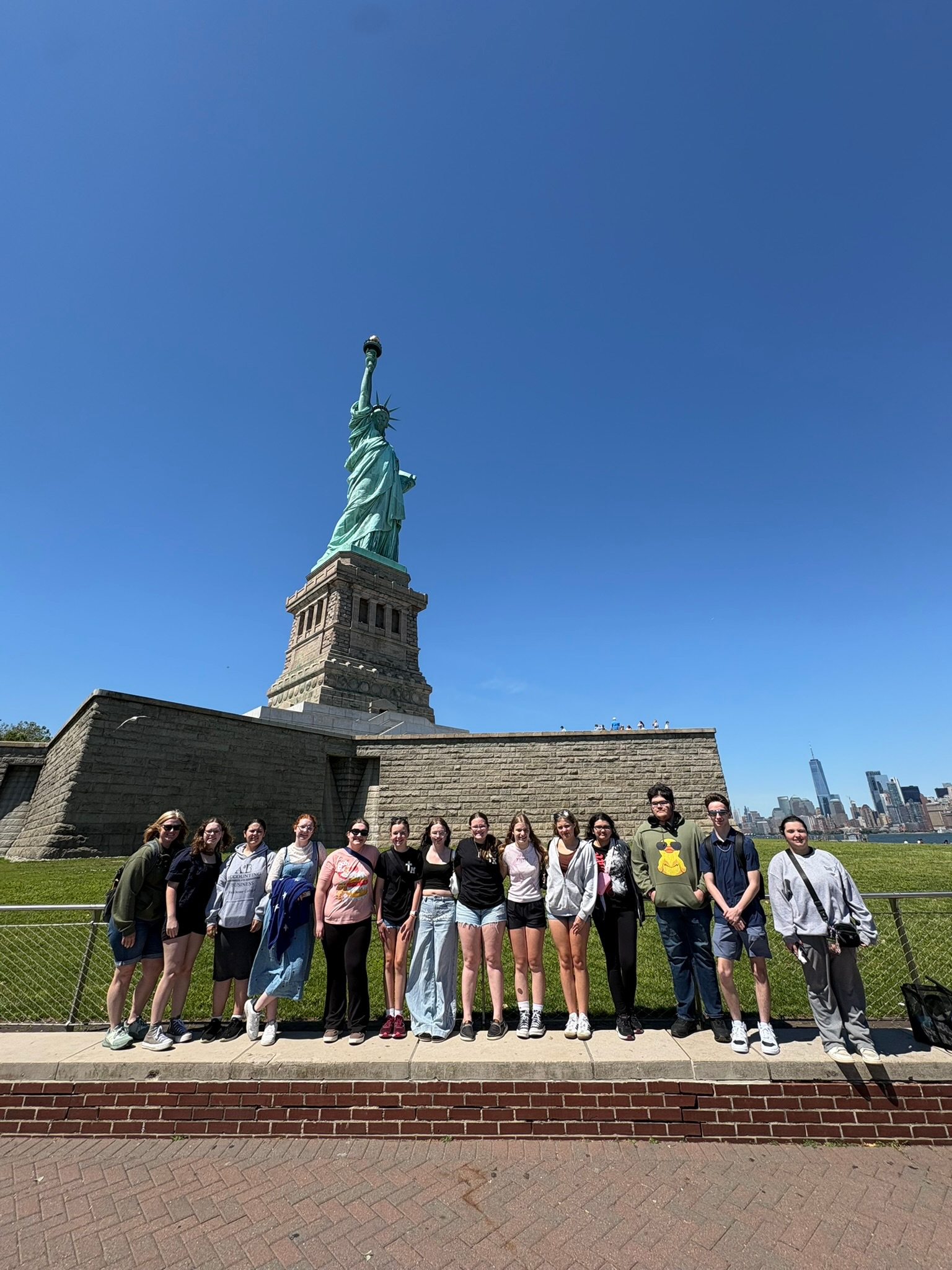 Photo of the Statue of Liberty with student travelers in the foreground