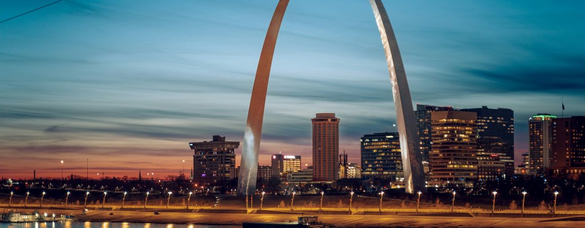 The Gateway Arch glowing at night in St. Louis, a high-value stop for student band trips