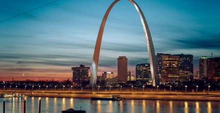 The Gateway Arch glowing at night in St. Louis, a high-value stop for student band trips